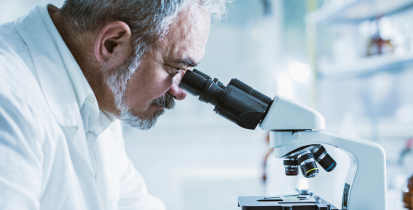 Un médecin qui regarde dans un microscope